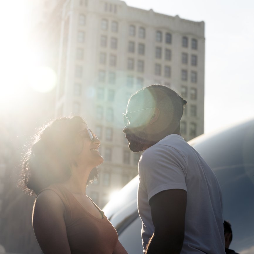 couple looking at each other outside the bean statue in chicago