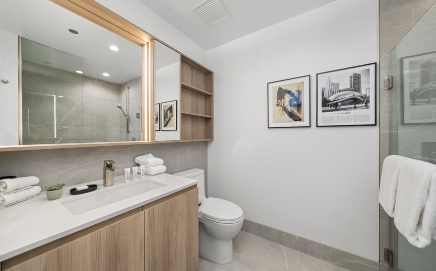 modern bathroom with malin goetz amenity and standing shower at level chicago fulton market