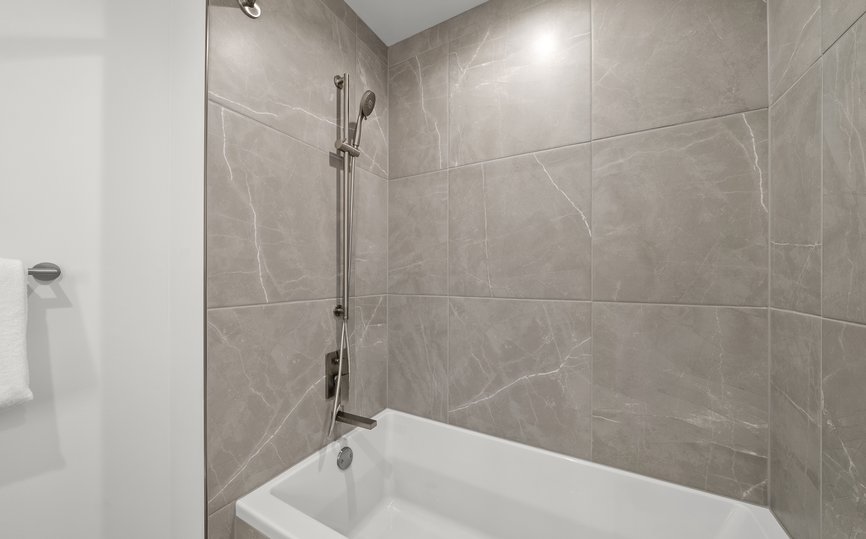 bathroom of three bedroom suite features bath tub at level chicago fulton market