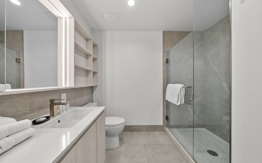 luxury modern bathroom features standing shower and malin goetz amenity at level chicago fulton market