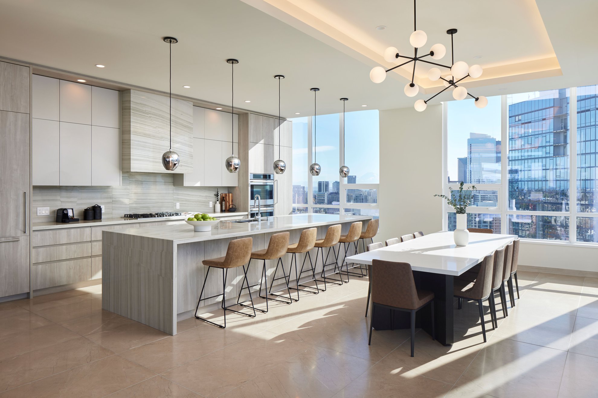 large kitchen with a dining area, long kitchen island, premium appliances and big window at level seattle oslu.jpg