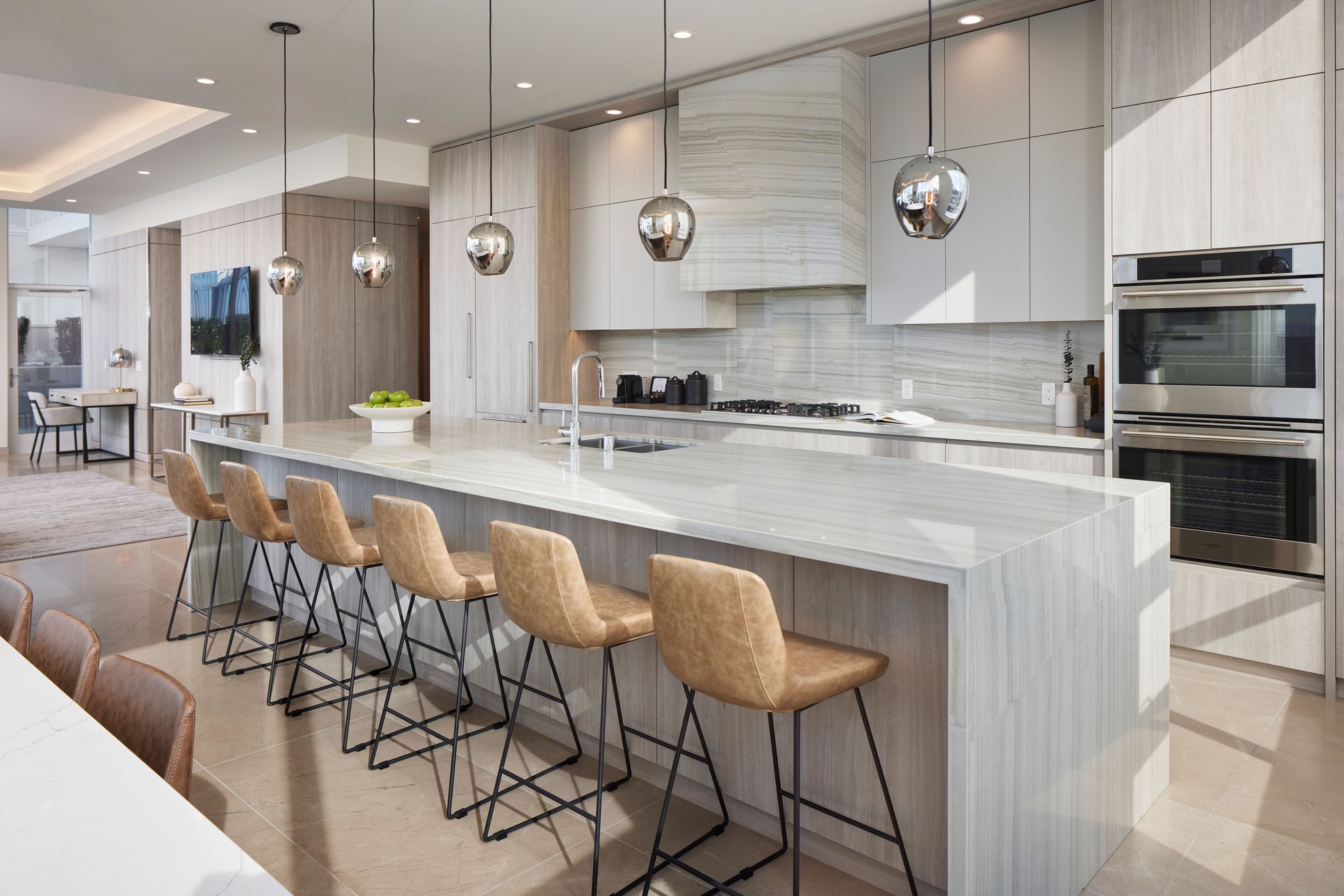 modern kitchen at penthouse level seattle features long island, stainless steel appliances, dining area.jpg